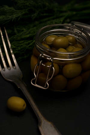 Fresh tasty olives dark with dillの写真素材