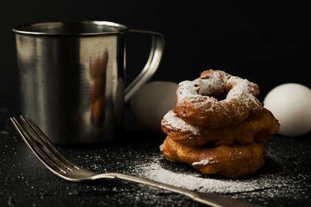 Freshly baked donuts with sugar powder, eggs and flour cooking processの写真素材