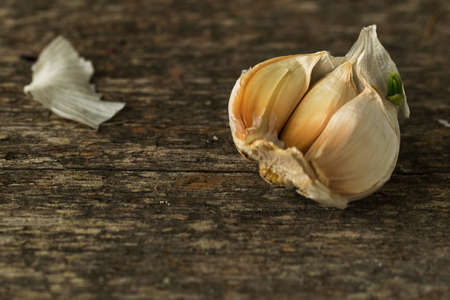 Garlic cloves on wooden desk macro toned selective focusの写真素材