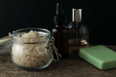 Bathroom accessories soap oils sea salt lavender aroma sachet on wooden desk toned selective focusの写真素材