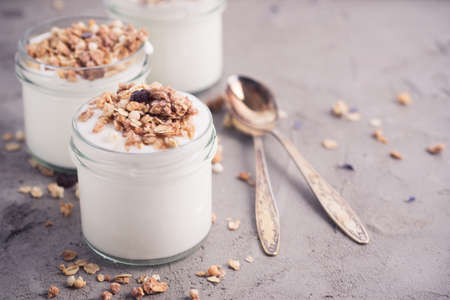 Yoghurt with granola made of oats, raisins, puffed rice, chocolate and dried bananas. Healthy...
