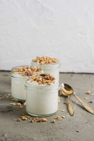 Yoghurt with granola made of oats, raisins, puffed rice, chocolate and dried bananas. Healthy...
