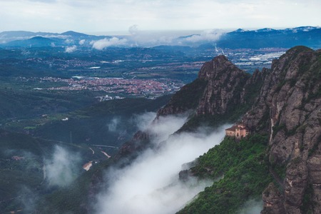 Mountains near Montserrat Abbey in Spain. Clouds and fog. Trees on cliffs. Summer holidays in mountains.の写真素材