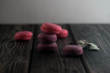 Group of macarons made of strawberries, cream, chocolate and blueberries. Rustic photo.の写真素材