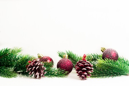Christmas fir branches with different decoration like scarlet balls, pine cones.の写真素材