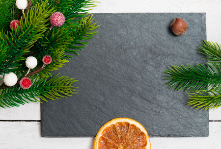Christmas fir branches with different decoration - citrus slices, sparkling balls and pine cones. Winter holidays.の写真素材