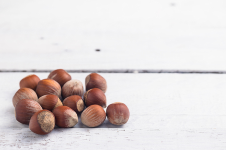Hazelnuts on white ristic wooden desk. Christmas mood.の写真素材