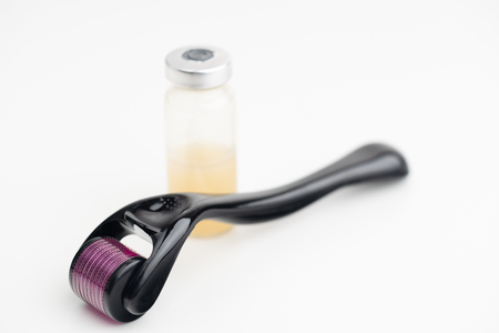 Dermaroller needle with serum in glass bottle. Anti wrinkle skin care.の写真素材