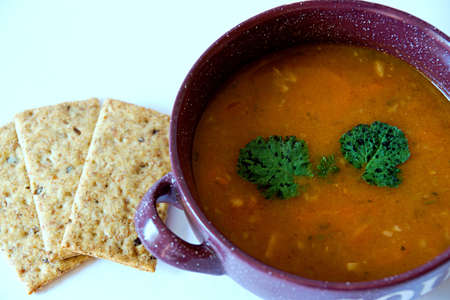Delicious spicy bean soup in an earthenware dish on a white backgroundの写真素材