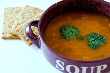 Delicious spicy bean soup in an earthenware dish on a white backgroundの写真素材