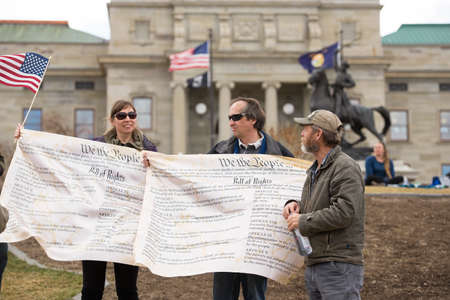 Helena, Montana - April 19, 2020: A man an woman protestor holding banners of the Bill of Rights in...