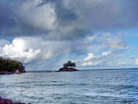 Rainbow above island         の写真素材