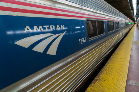 New York City, Circa 2017: Amtrak train at Penn Station railroad terminal platform Manhattan. Red...