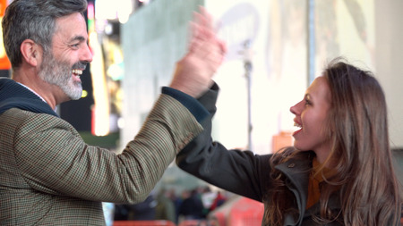 Young couple celebration high five gesture. Great friend relationship on loving date at night. Touching sign of intimacy and achievement.の写真素材