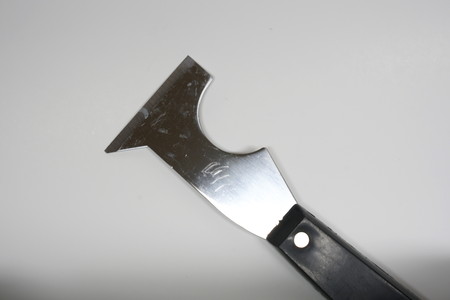Isolated photo of a handy painters tool. Opening paint cans and scraping to clean brush and roller