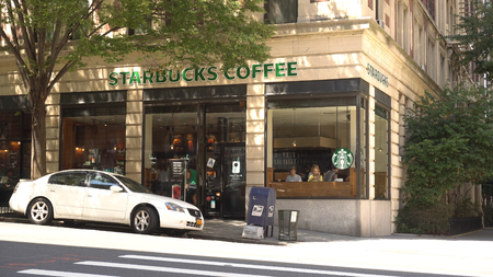 New York City - August 14 2016: Starbucks coffee retail location on upper east side Manhattan. People visit in morning for daily caffeine intake and expensive drinksのeditorial素材