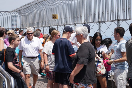 New York City, NY - July 12 2016: Tourists gather on the observation deck of the Empire State...