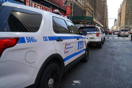 New York City - September 2016: NYPD cruiser patrol cars along side a Manhattan avenue. Police Department officers protect and serve the people to ensure safety from criminals and terrorist threats.のeditorial素材