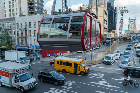 New York City, Circa 2017: Roosevelt Island Tram crosses above busy traffic in Manhattan during day timeのeditorial素材