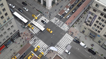 New York City, Circa 2017: Overhead aerial birds eye view overhead busy Manhattan intersection day time. People, bus, yellow taxi traffic travel downtown avenue.のeditorial素材