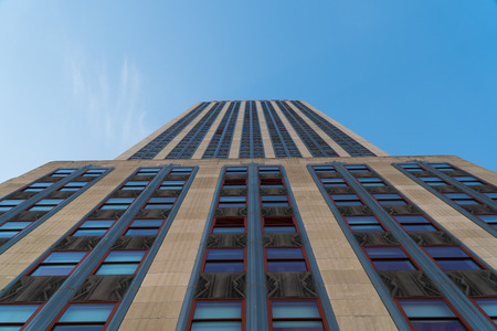 New York City - Circa 2017:  Empire State Building. Straight up vertical photo towards the sky up the side of the historical landmark building. Tourists visit observation desk overlooking Manhattanのeditorial素材