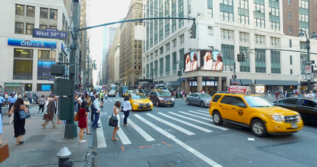 New York City, Circa 2017: Overhead wide view of busy Manhattan intersection during morning commute rush hour. Yellow taxi cab drive by on streetのeditorial素材
