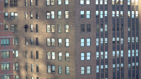 Exterior establishing shot of New York City urban style generic apartment building from above during the day time.の写真素材
