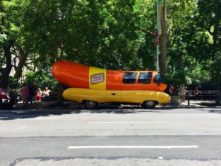 New York City, Circa 2017: Oscar Mayer Wiener mobile outside Manhattan park on summer day. Promotional advertising vehicle shaped like hot dogのeditorial素材