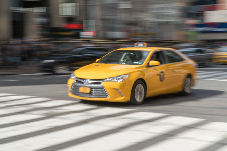 New York City, Circa 2017: Fast motion blur of NYC yellow taxi cab driving through busy manhattan...