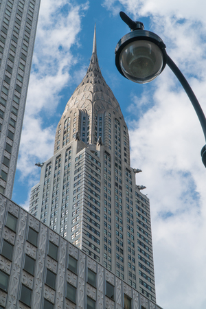 New York City, Circa 2017: View of Chrysler Building from street level, light pole in foreground. Vertically framed blue sky clouds in backgroundのeditorial素材