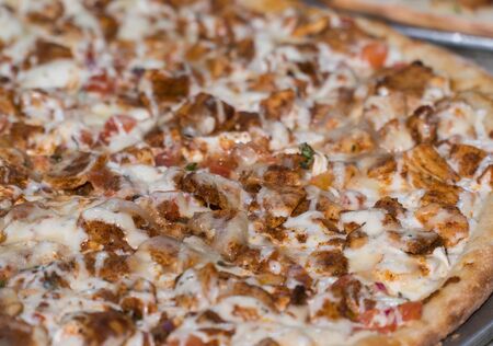 Close up stock photo of typical generic chicken pizza pie with cheese and toppings delicious and made to order from restaurant menuの写真素材