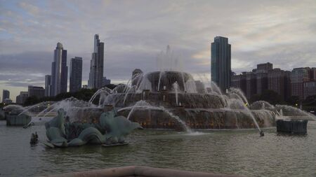 Famous buckingham fountain in Chicago park outside downtown with beautiful sunset skyline in background.の写真素材