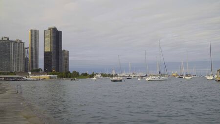 Day time exterior establishing shot of lake Michigan on Chicago shore front with sky scraper skyline from downtown reaching river side areaの写真素材