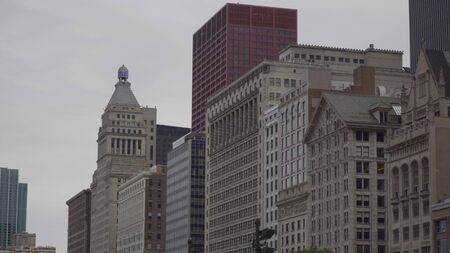 Exterior day time establishing shot of urban cityscape skyline of apartment buildings in row along park road. Generic view for Chicago or New York Cityの写真素材