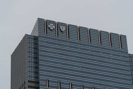 Chicago, USA - Circa 2019: Blue Cross Blue Shield commercial real estate building corporate headquarters downtown with emblem logos on top of building facade.のeditorial素材