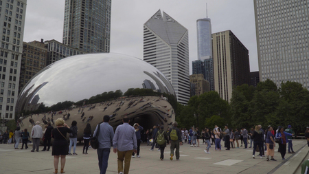 Chicago, USA - Circa 2019: Famous cloud gate art sculpture in downtown park made of steel reflecting cityscape skyline on Chicago beanのeditorial素材