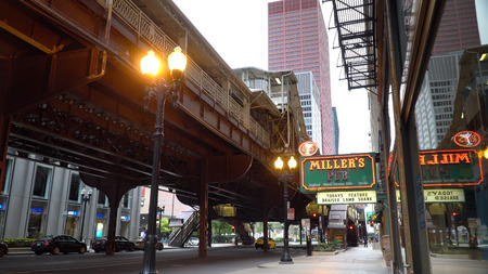 Chicago, USA - Circa 2019: Day time exterior Millers Pub in downtown Chicago under the L train tracks over street level. Color over sign for generic usageのeditorial素材