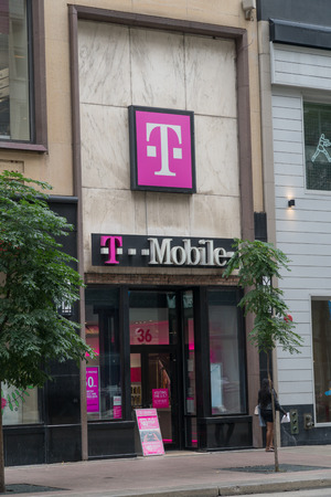 Chicago, USA - Circa 2019: T-Mobile retail store location exterior storefront facade photo. Wireliess cell phone service provider.のeditorial素材