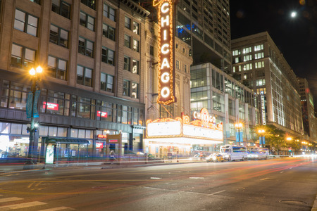 Chicago, IL - Circa 2019: Chicago landmark theatre famous venue in downtown. Night time exterior establishing shot long exposure of traffic light trails passing marquee lit up logo signのeditorial素材