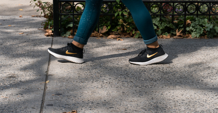 New York City, Circa 2019: Woman joggingin workout tights wearing Nike running sneakers for athletic footware by famous company brandのeditorial素材