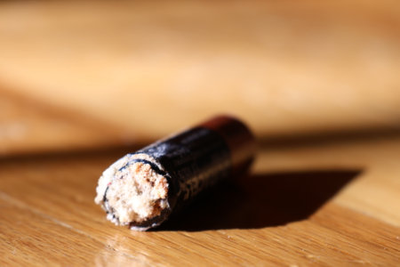 A double a battery with acid corrosion build up on the outside.の写真素材