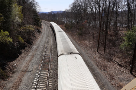Train on the railway tracks in the forest. View from above.の写真素材