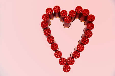 Shotgun shells in heart shape with pink backgroundの写真素材