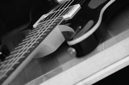 Black and white guitar on chair focused on pickups