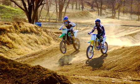 Two dirt bike riders down the long stretch.の写真素材
