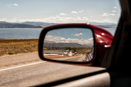Reflection in the side mirror of a car on a road tripの写真素材