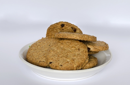 Cookies with cup of milk on white background
