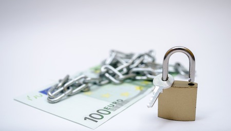 euro bill with padlock and chain as a concept of securityの写真素材