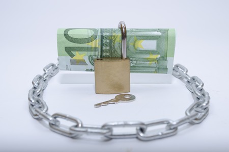 euro bill with padlock and chain as a concept of security