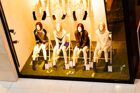 Boutique window with four mannequinsの写真素材